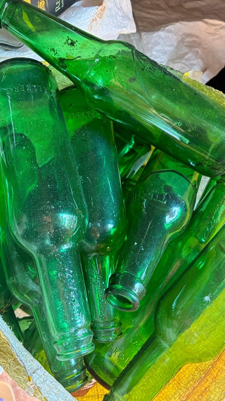 Women cleaning glass bottles
